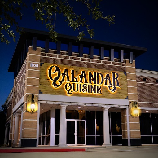 The Qalandar Quisine storefront on West Airport Boulevard at dusk.